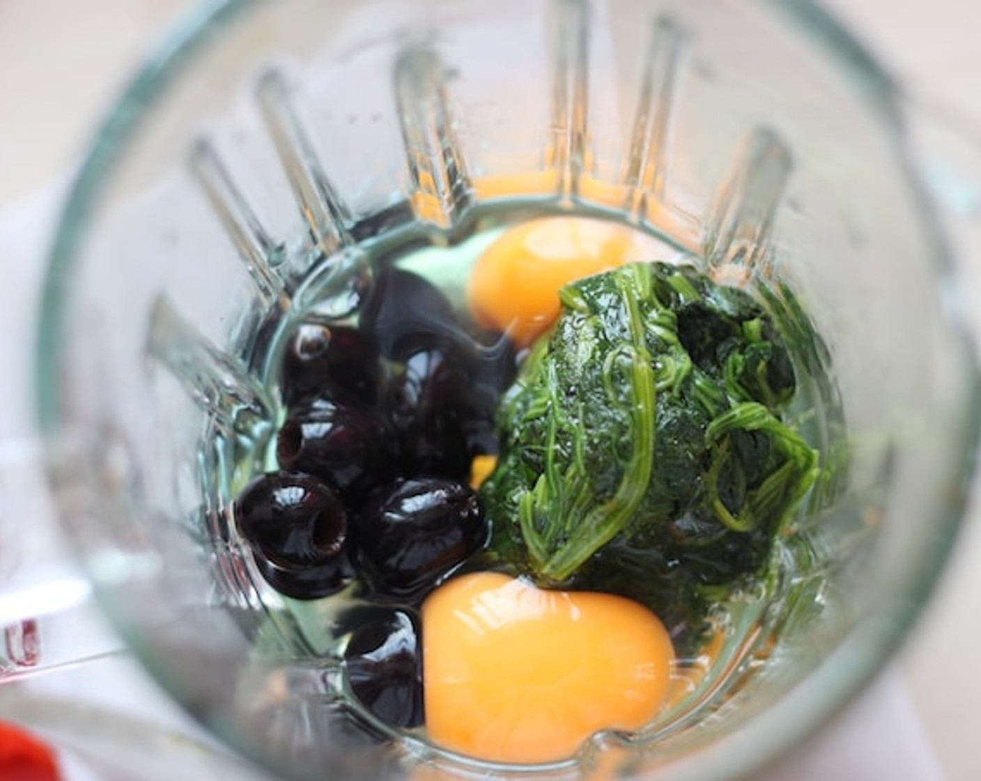 step 7 To make the Ohmu we are going to put the Black Olives (3/4 cup), boiled spinach, Eggland's Best Classic Eggs (3), and a pinch of Limes (2) all into the blender.