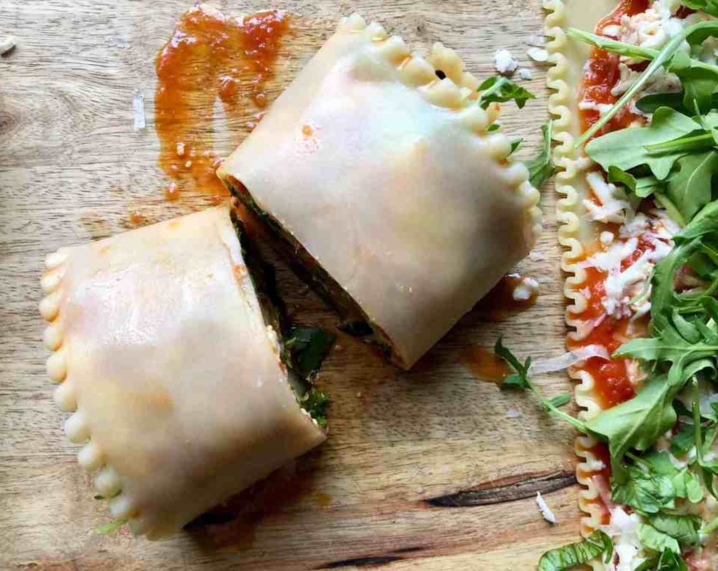 step 10 Use a sharp knife to slice the lasagna roll in half to make 2 spirals. Place each piece in the baking dish cut-side down with the wavy edges of the noodle facing up.