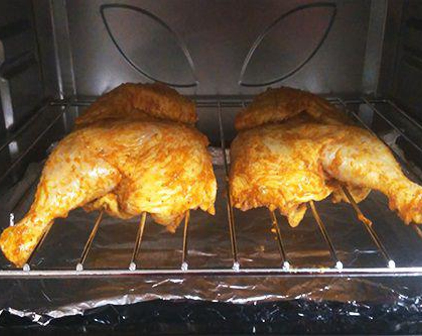 step 4 Here it is grilled in an oven. For that preheat the oven at 400 degrees F (200 degrees C). Place the chicken on the grill tray. You should place another tray below so that all the drippings get collected in it.
