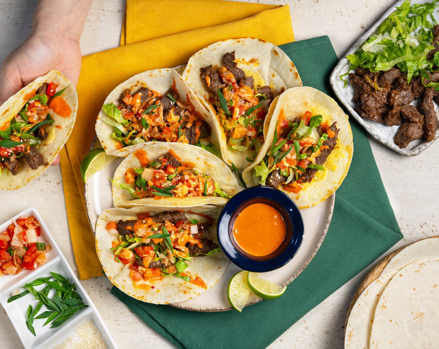 step 10 To assemble the taco, top the cheesy tortilla with beef, Romaine Lettuce (1), kimchi pico de gallo, gochujang mayo, and Toasted White Sesame Seeds (1 tsp). Serve along with the cocktails and enjoy!