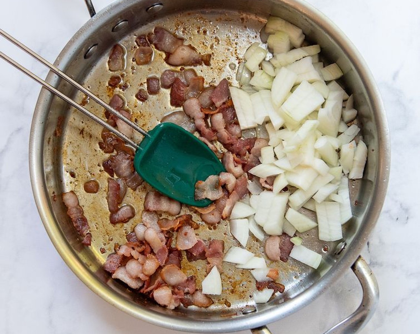 step 2 Heat a large ovenproof skillet over medium heat. Add the Bacon (4 slices) and cook about 3 minutes, or until about halfway cooked. Add Yellow Onion (1) and continue cooking until bacon is crisp and onions are soft and translucent, about 4-5 minutes longer. Add Garlic (2 cloves) and sauté 30 seconds longer.