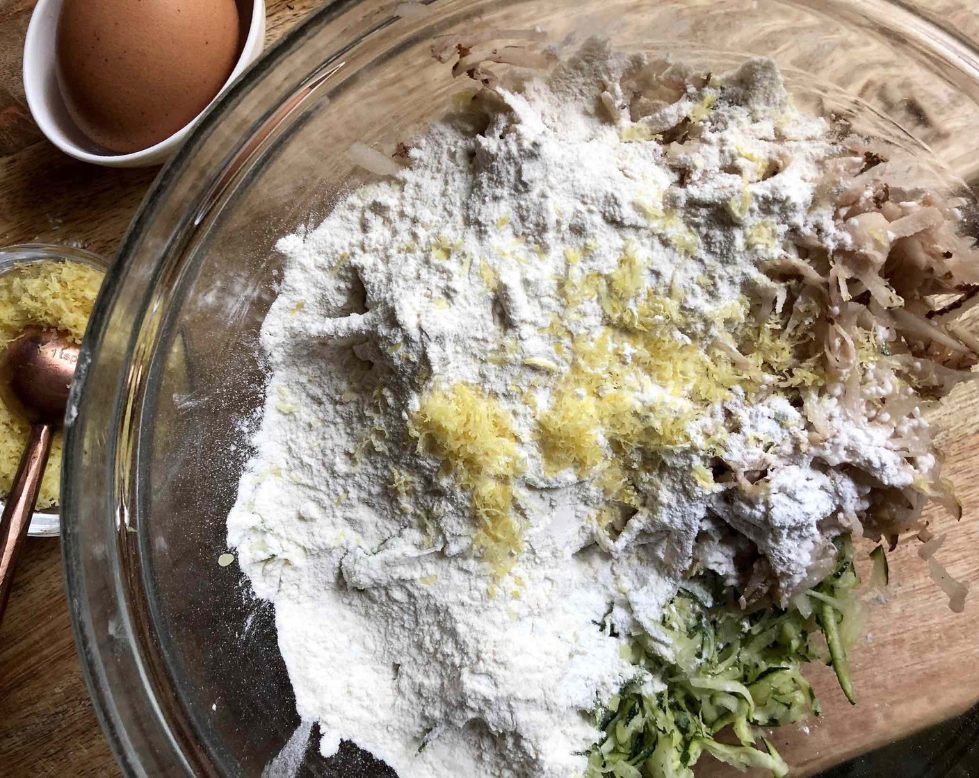 step 3 Transfer zucchini to a large bowl. Add the Russet Potatoes (8 oz) to the zucchini along with 1 teaspoon lemon zest, All-Purpose Flour (1/2 cup), Baking Powder (1/2 tsp), and Cayenne Pepper (1/8 tsp), and toss to mix well.