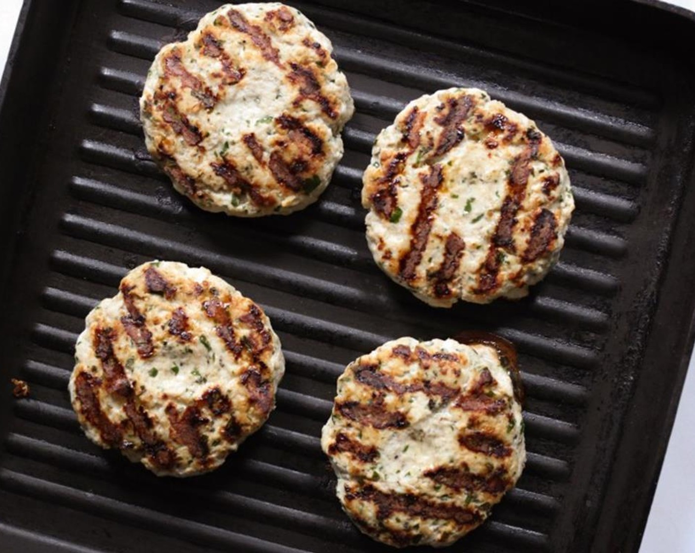 step 7 Place the burgers on the hot grill, thumbprint side down, and cook for 5-6 minutes per side until cooked through.