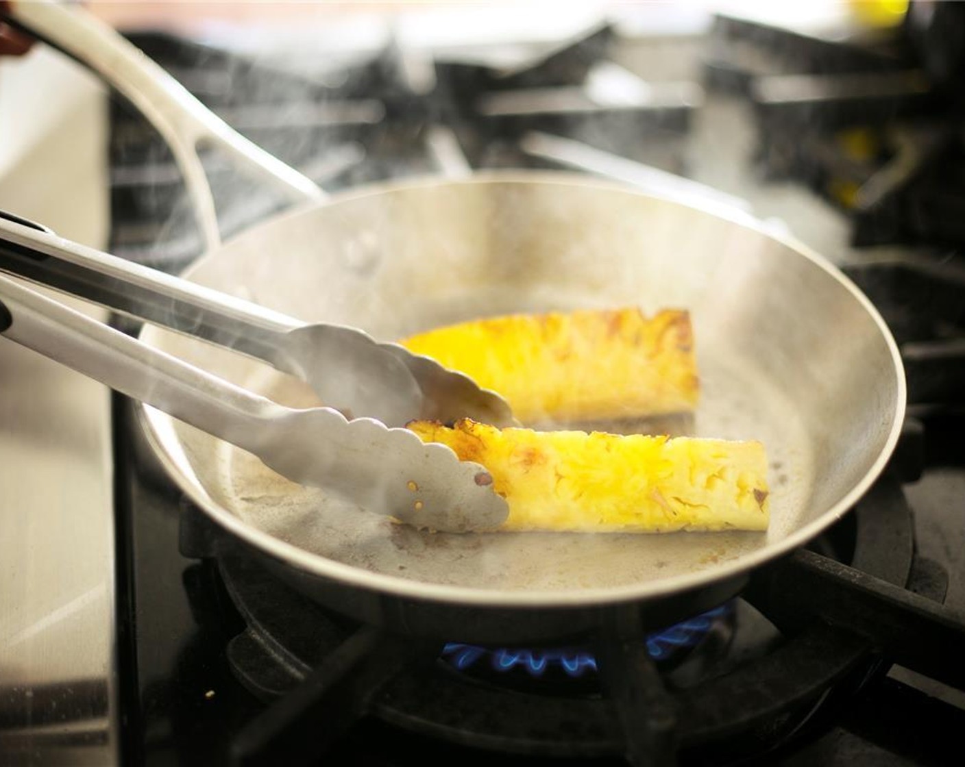 step 11 Meanwhile, in a medium sauté pan over high heat, add Oil (1 tsp). Once oil is hot, add Pineapple Spears (2) and sear one side for approximately 3 minutes, or until there is a golden sear.