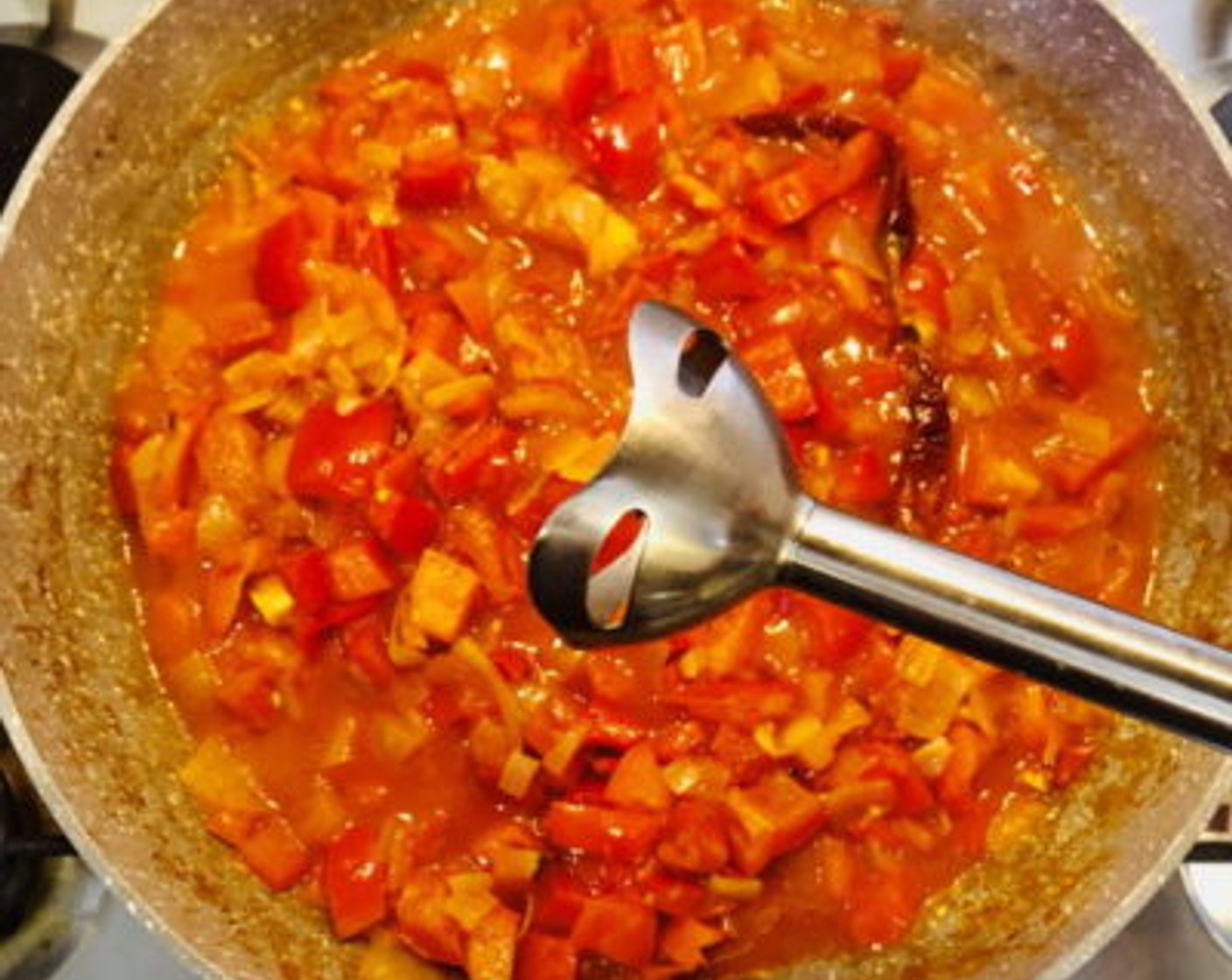 step 4 Add one-quarter of the Chicken Stock (1/2 cup) and allow the red bell pepper and tomatoes to simmer and break down for about 10-15 minutes until tender. Turn off the heat and either using a stick blender or transferring contents to a stand blender to puree until completely smooth.