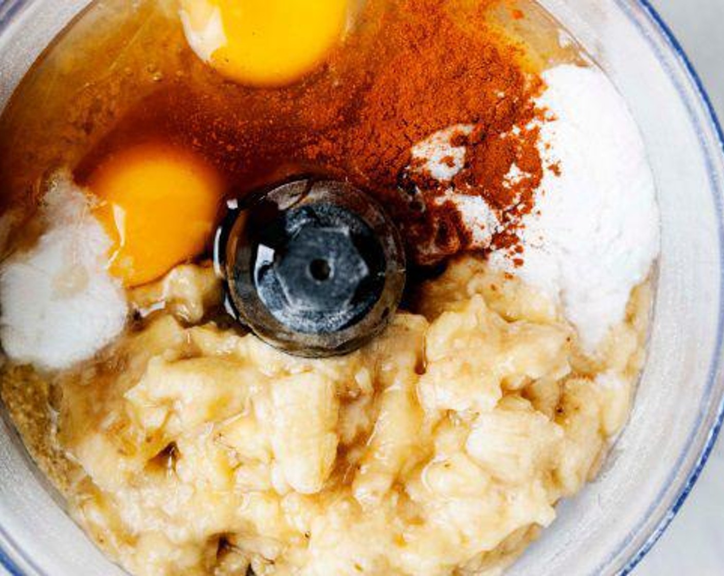 step 3 To the blender/food processor add Coconut Vinegar (1 Tbsp), Mashed Banana, Eggs (3), Baking Powder (1 tsp), Baking Soda (1/2 tsp), Maple Syrup (1/4 cup), Vanilla Extract (1 tsp) and Ground Cinnamon (1 tsp). Pulse until all ingredients are combined