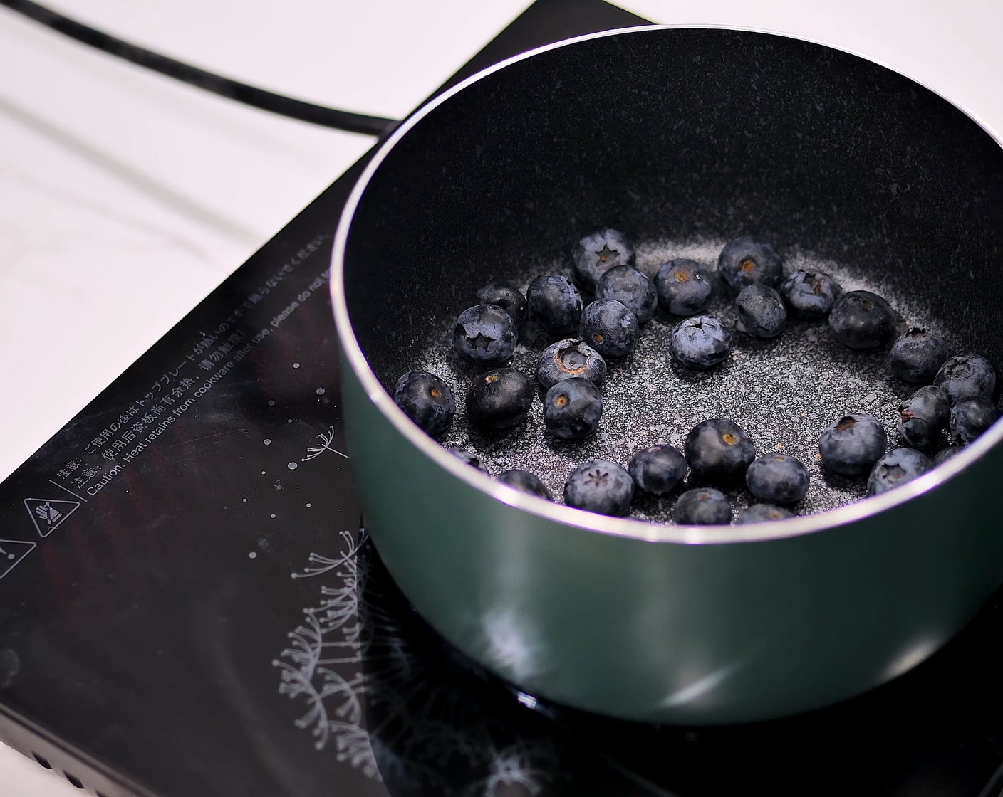 step 16 To make the Blueberry Jelly Layer, in a saucepan, add Fresh Blueberry (1/2 cup), Water (2 Tbsp), and Granulated Sugar (1 Tbsp). Bring it up to a boil and cook the berries for a minute or two until the mixture is thoroughly purple and the berries are soft.