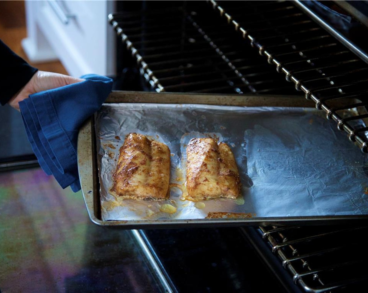 step 14 Pat dry Cod Loins (2) with paper towels. Rub the mixture onto both sides of the fish, making sure the top sides are well coated. Place onto a rimmed baking sheet lined with foil and roast for seven minutes or until fish flakes easily with a fork. Remove from oven.