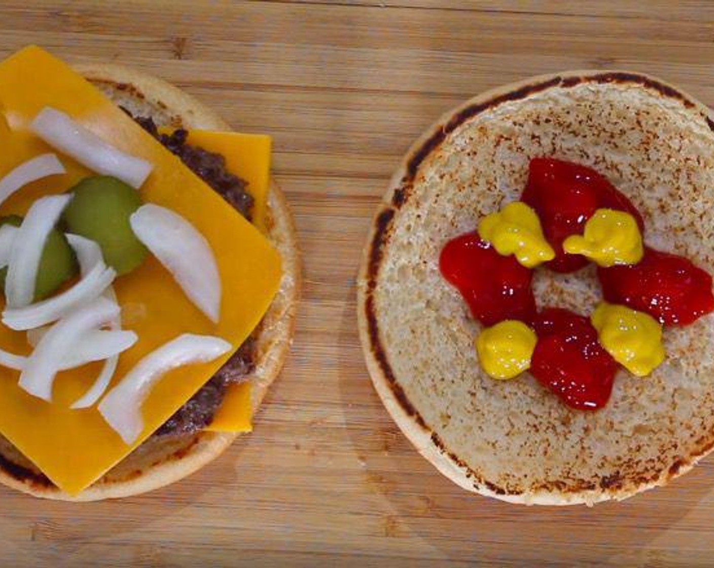 step 4 To assemble, lay out Sesame Hamburger Buns (4). On the heel bun, layer one slice of American Cheese Slices (8), beef patty, the other slice of cheese, two Pickles (8 slices), and Onions (to taste). On the crown bun, add Ketchup (to taste) and Yellow Mustard (to taste).