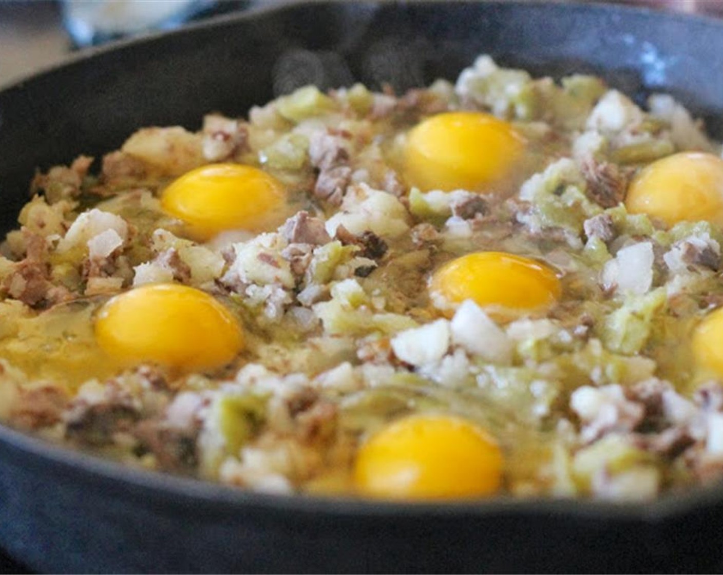 step 5 With a large spoon, make indentations in the hash. Crack the Eggs (6) and place one in each indentation. Cover with foil and bake until bottom is crispy and eggs are cooked to desired amount, about 10- 20 minutes.