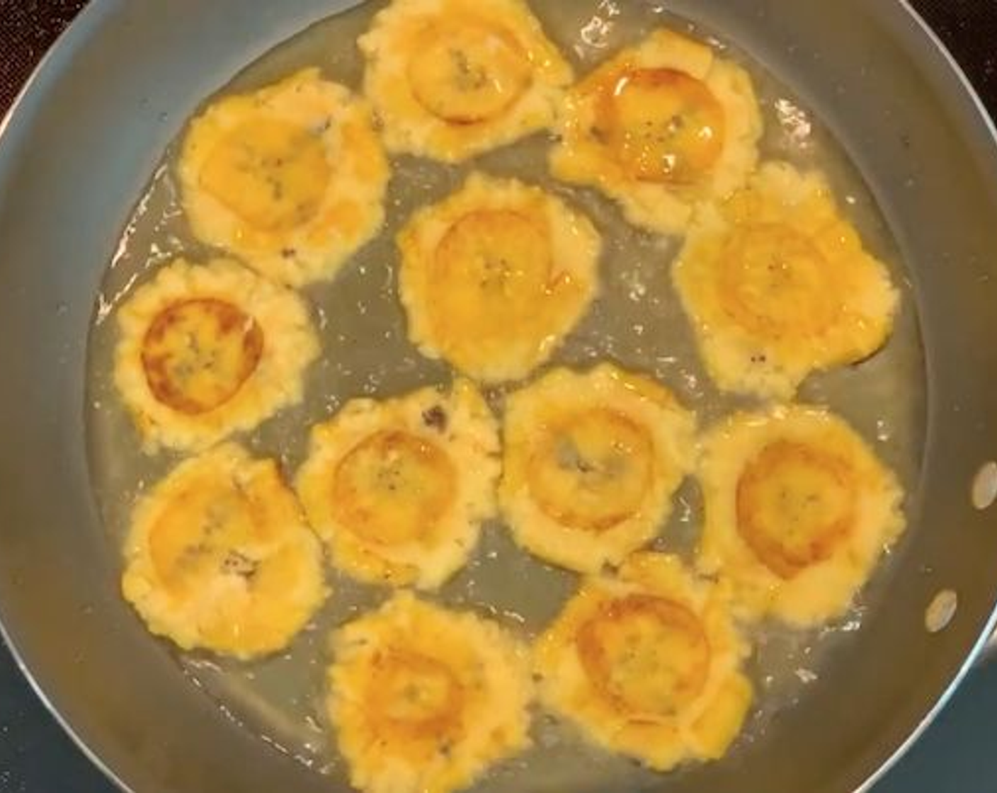 step 4 Take the green plantain circles and flatten them. You can smash them with the bottom of a plate, pan, or cup. Put the flattened plantains back in the oil and fry for another 2-3 minutes until nice and crunchy. Remove the plantains and drain them on paper towels.