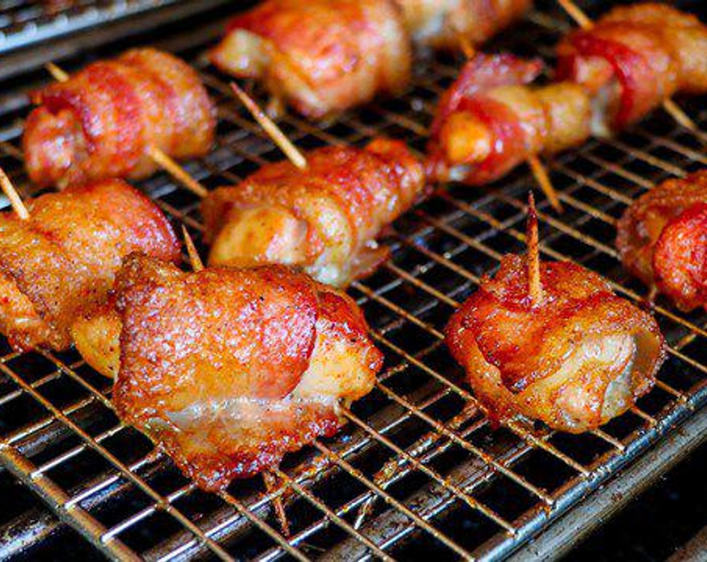 step 4 Place the chicken bites onto the grill and cook for about 45 minutes or until the bacon is completely brown and sticky.