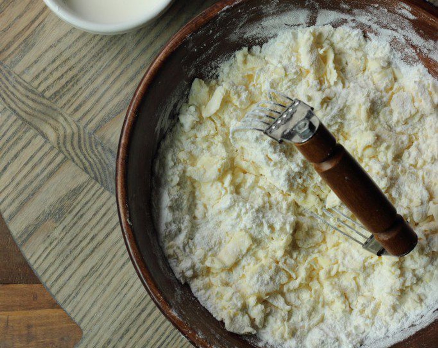 step 9 Drizzle 1/2 of the liquid (ice water, sour cream and vinegar) over flour and butter mixture and gently mix together with a fork. Drizzle the other 1/2 of the liquid and continue gently incorporating.