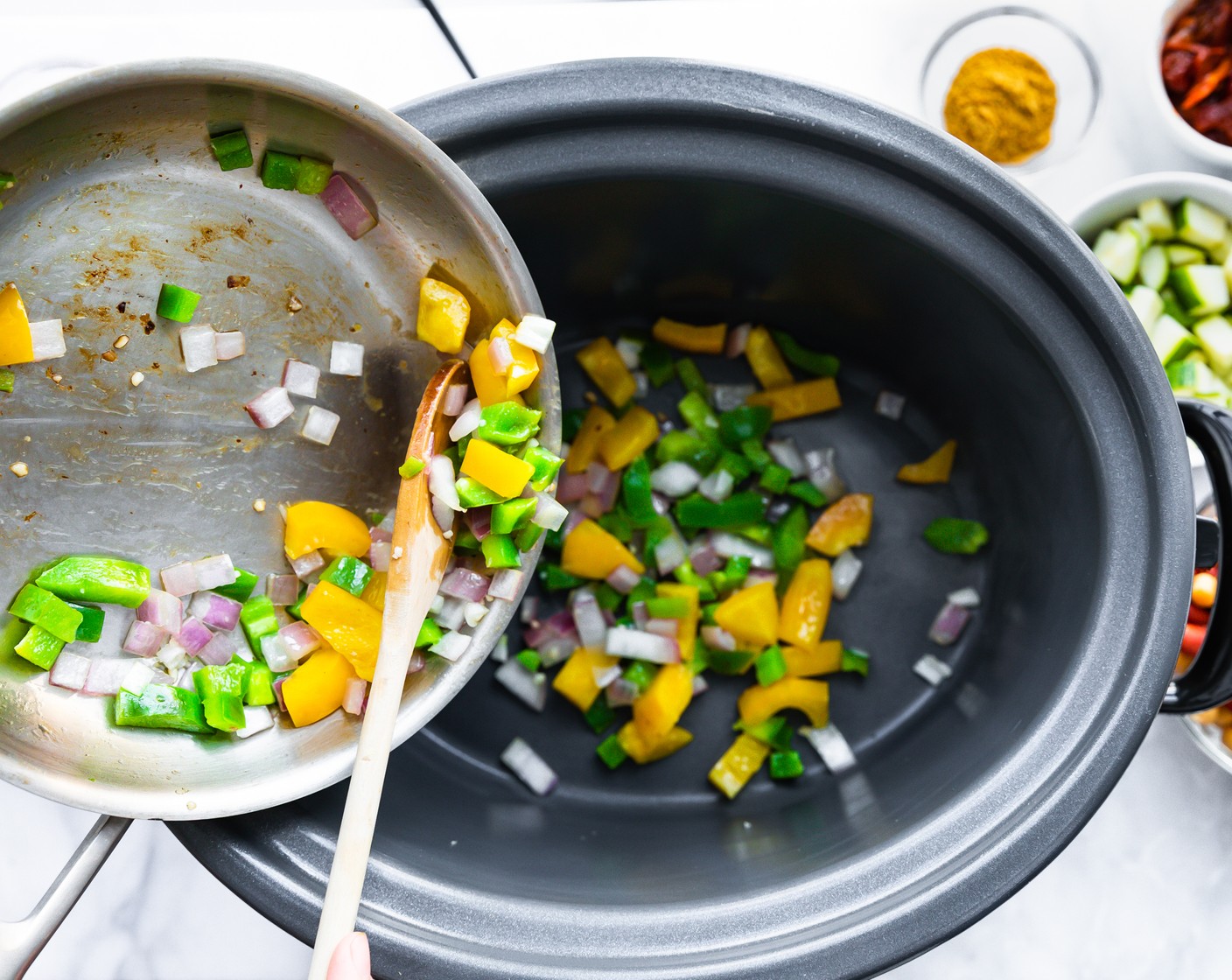 step 1 Add Olive Oil (1 Tbsp) to a skillet over medium heat. When hot, add and sauté Red Onion (1), Garlic (3 cloves), and Bell Peppers (2) for 3-5 minutes. Once cooked, transfer to the slow cooker.