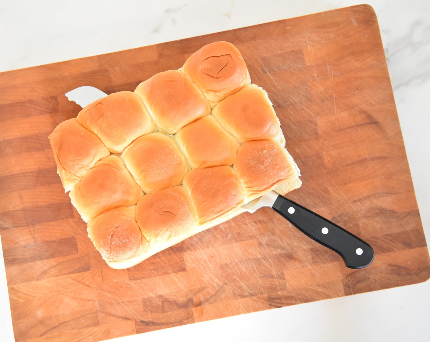 step 2 Slice the Hawaiian Roll (1 pckg) in half and remove the top half of the rolls and set
aside.