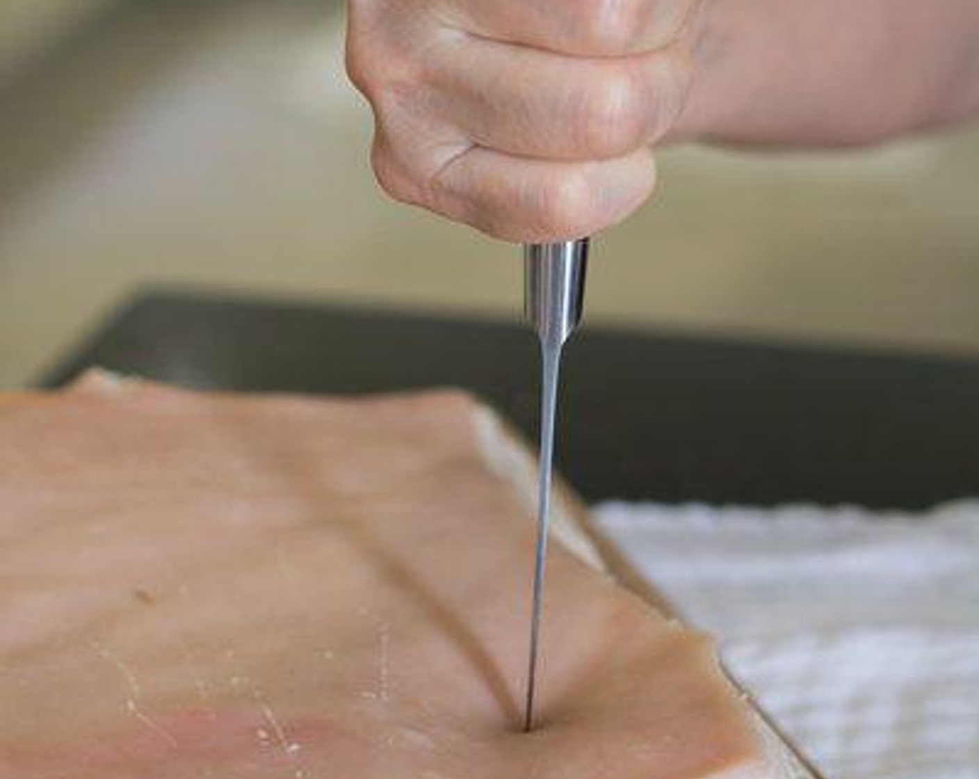 step 3 Using a pointed sharp knife or a pork belly skin hole hammer, poke tiny holes on the entire surface of the skin. Lots and lots of holes.