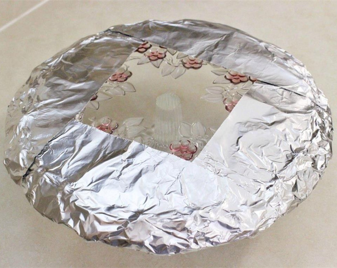 step 12 Line the edges of a cake stand or plate with sheets of aluminum foil. (This is to facilitate easy clean up later.)