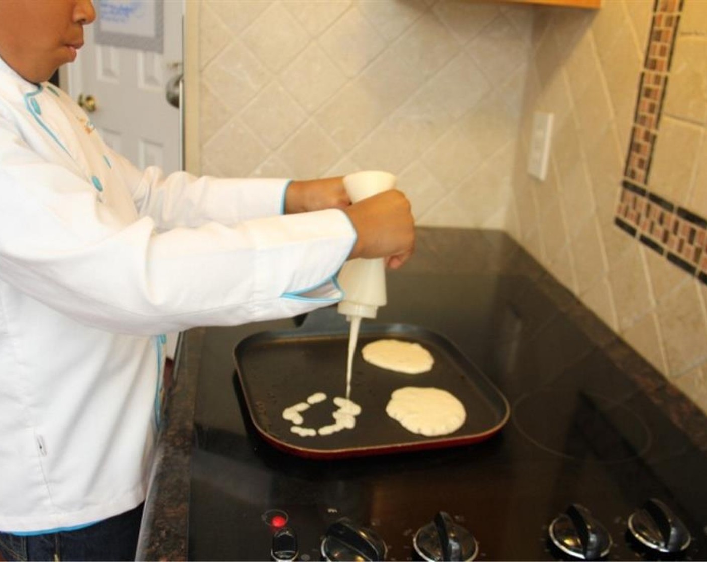 step 4 Spray a griddle or frying pan with cooking spray and add a small circle of pancake batter onto the hot pan.