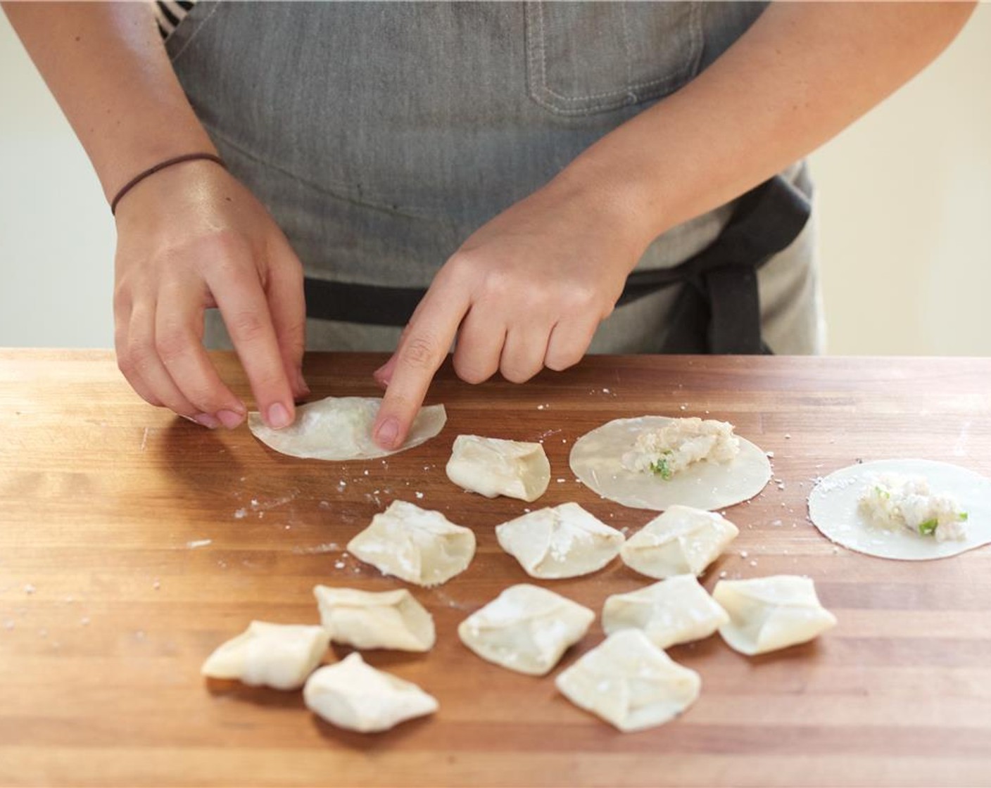 step 5 Sprinkle remaining Corn Starch (1 Tbsp) on a dry work surface. Lay the Dumpling Wrappers (12) directly on the cornstarch. Scoop one teaspoon of shrimp filling on each wrapper.