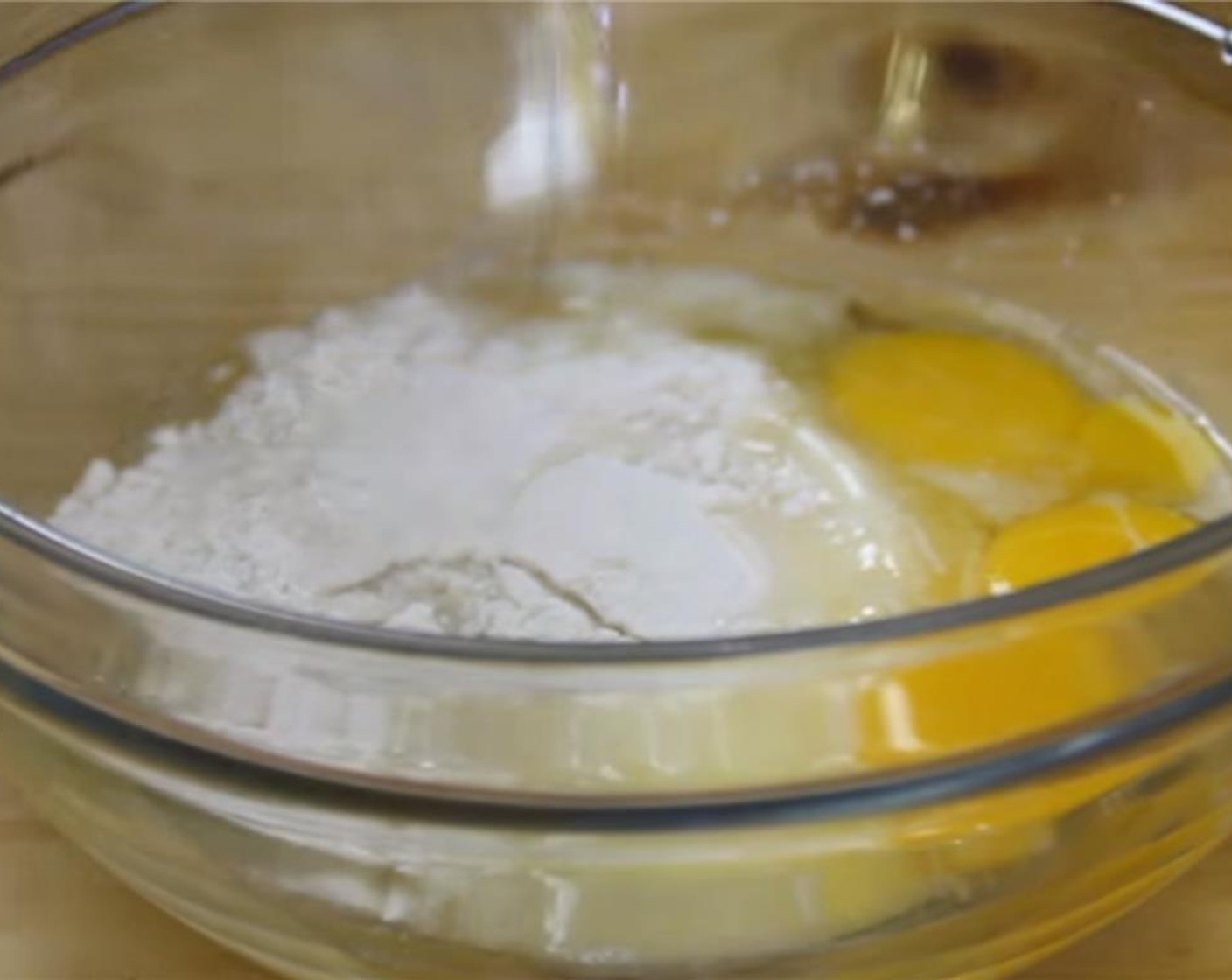 step 6 In a separate bowl, combine Eggs (3), All-Purpose Flour (2 1/2 Tbsp), Granulated Sugar (1 cup), and Lemons (2). Mix until they are well incorporated.