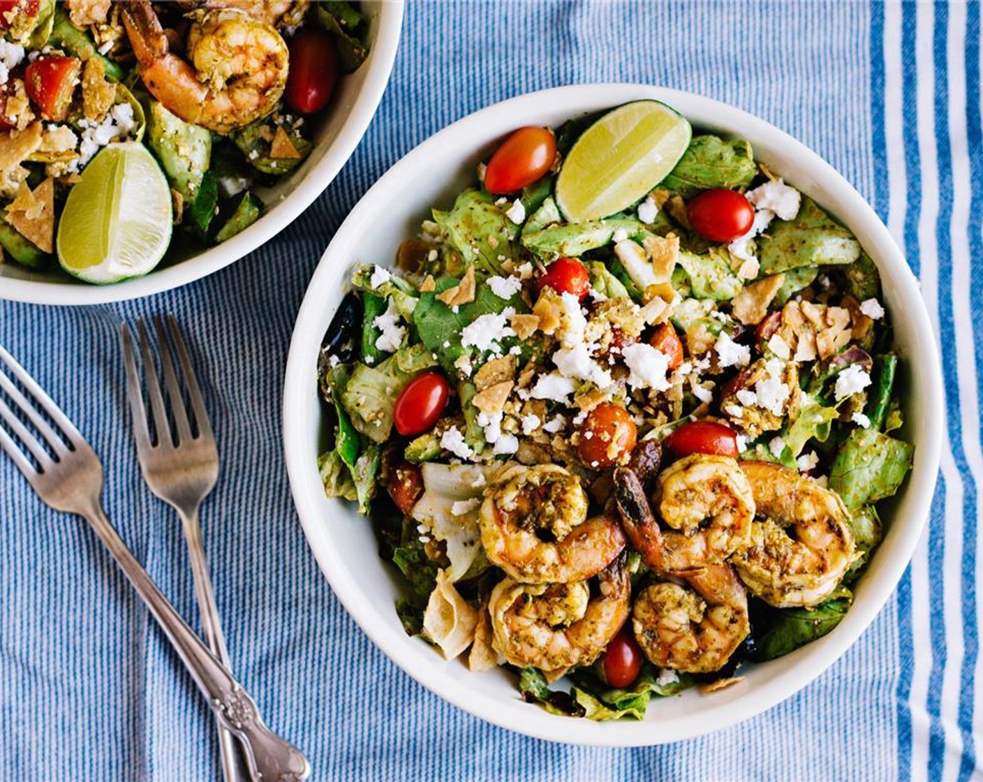 step 10 Divide the salad into bowls. Top with shrimp and serve with extra lime wedges. Serve and enjoy!