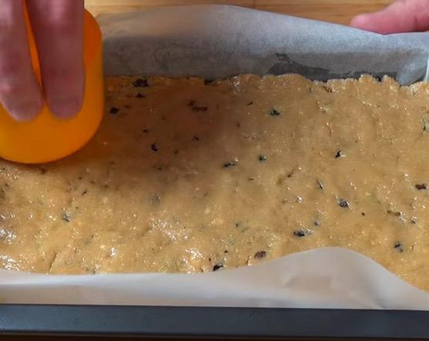 step 4 Transfer the batter into a lightly greased 30-centimeter by 20-centimeter slice pan, lined with non-stick baking paper. Make sure the surface is smooth and even.