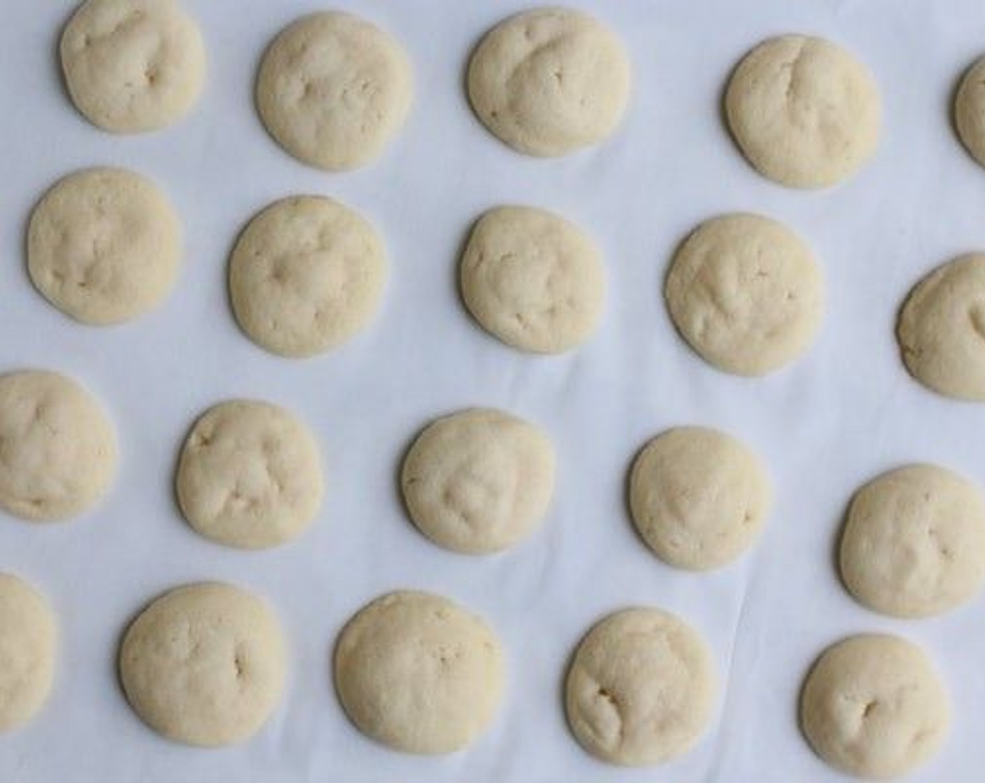 step 6 Bake one pan at a time in preheated oven, until cookies are slightly puffy and edges have begun to set and the bottoms are lightly golden brown, about 11-13 minutes (mine took exactly 12 minutes).