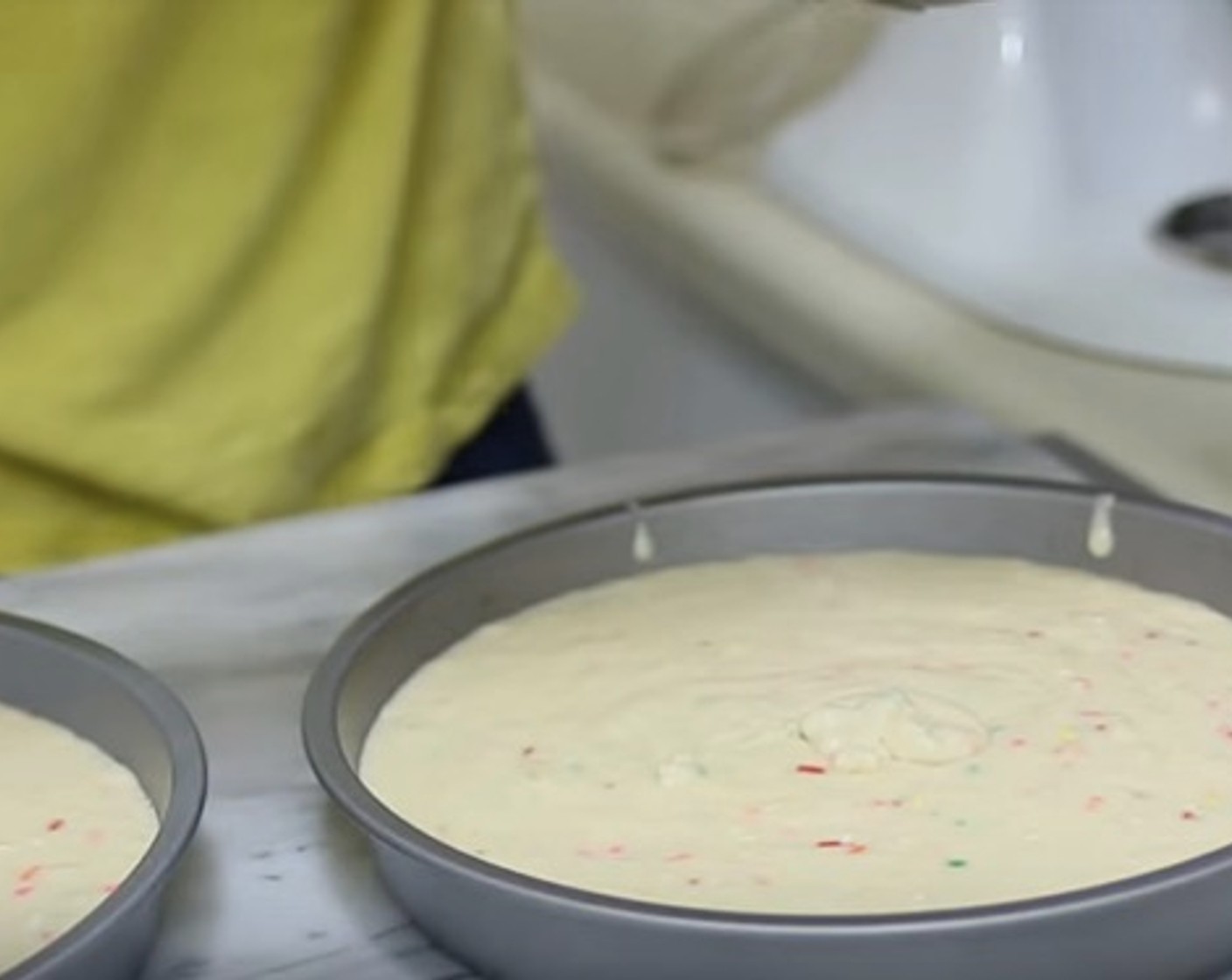 step 6 Divide the cake batter into the two cake pans. Bake them for 30-35 minutes or until a toothpick inserted in the middle comes out clean.