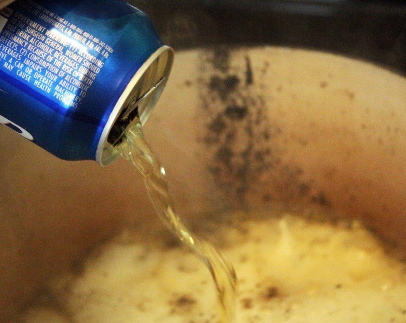 step 7 Add the entire can of Beer (12 fl oz) to the pot. It'll bubble and foam - stir it into the bottom of the pot to release any meat drippings.