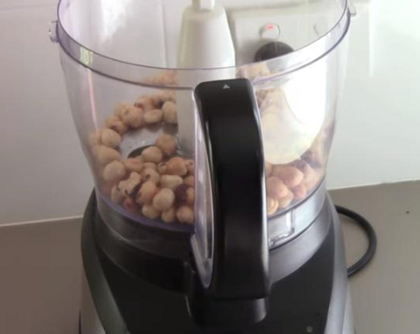 step 1 Into the food processor, add and process the Hazelnuts (1 3/4 cups).