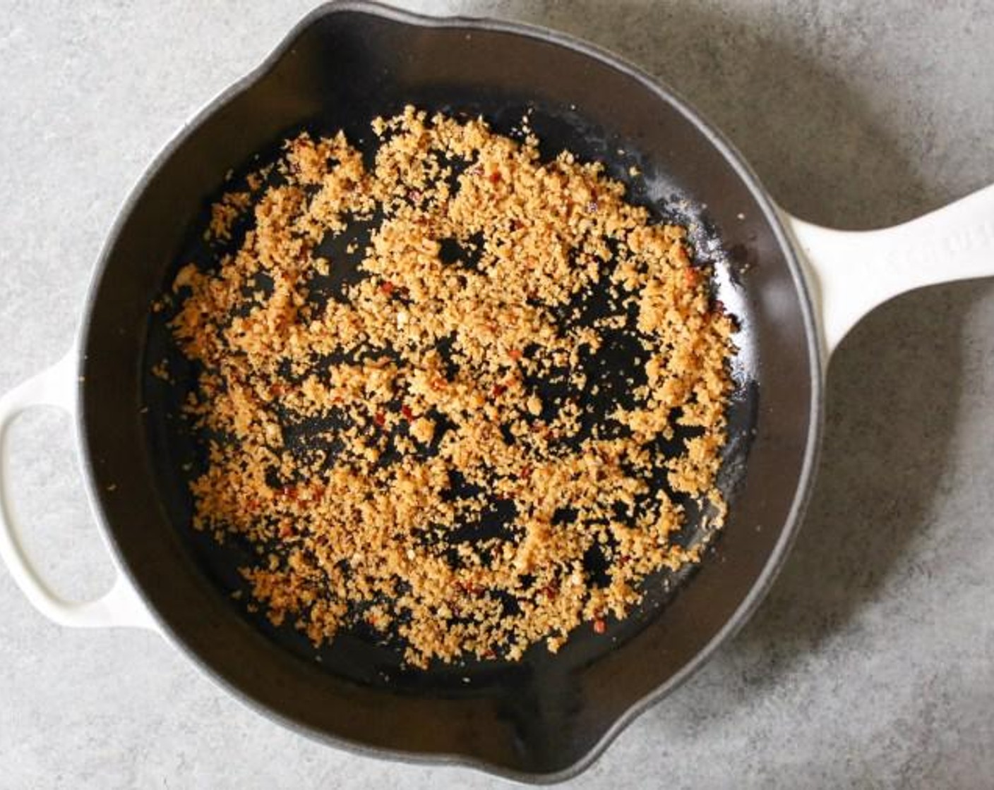 step 4 While the quinoa cooks, prep the panko topping. Heat Extra-Virgin Olive Oil (1/2 Tbsp) in a large ovenproof skillet or sauté pan over medium heat. When the oil is hot and shimmering, add the Garlic (2 cloves) and Crushed Red Pepper Flakes (1/2 tsp) and cook just until the garlic begins to turn golden, about 30 seconds.