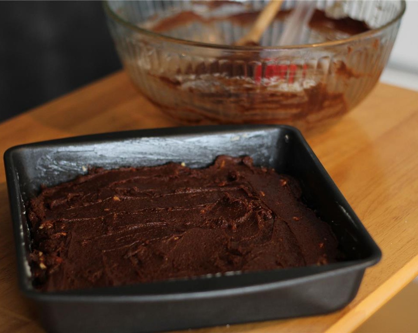 step 5 Spread the batter evenly into the baking dish, and transfer to the oven to bake for 25 minutes, or until the top is set and a toothpick inserted into the center of the pan hangs onto a few moist crumbs.