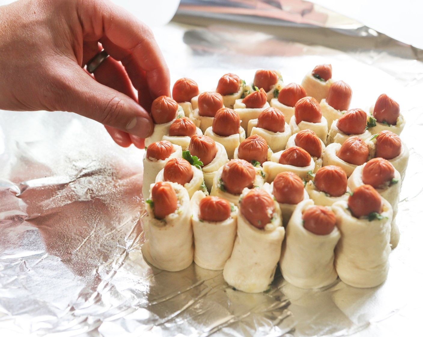 step 6 Stack the wrapped smokies in a circle in the center of the prepared foil so the smokies are all standing on end.