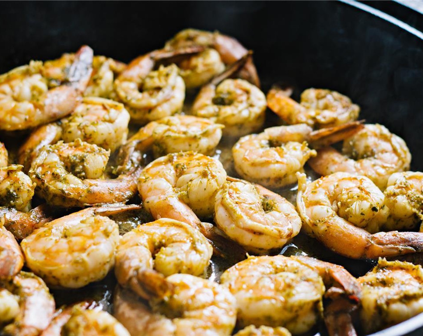 step 9 Heat a heavy skillet over medium-high heat. Add in the shrimp and cook for about 2 minutes per side or until cooked through and bright pink.