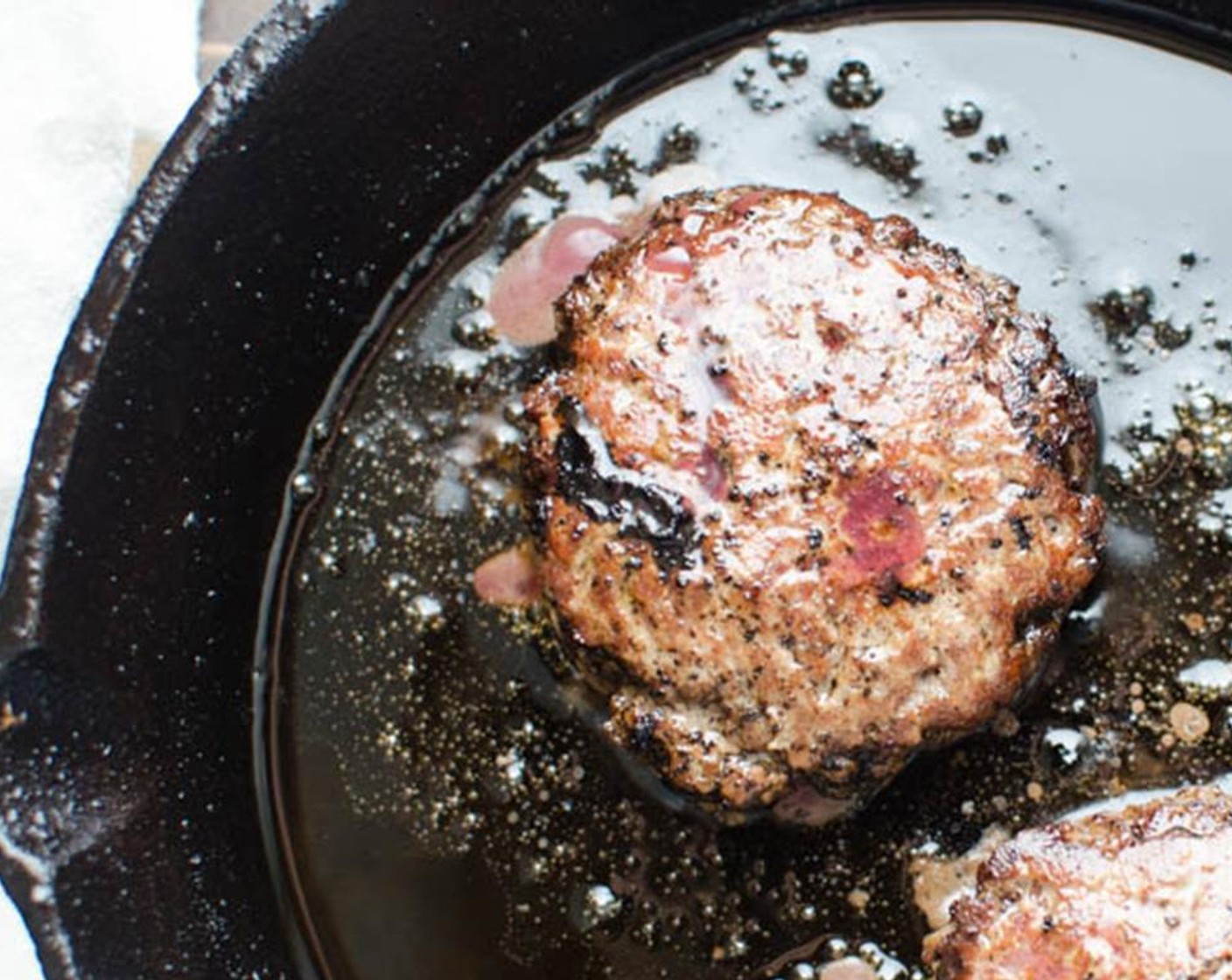 step 11 Cook 1 to 2 minutes and carefully flip the burgers to cook the other side. 1 to 2 minutes per side for medium rare. Transfer the burgers to a platter and continue to cook the other burgers.