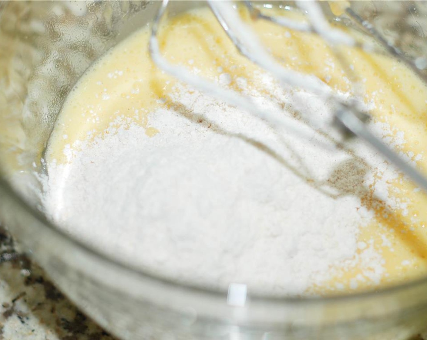 step 6 Add the flour mixture a little at a time, mixing on low speed. Scrape down the side of the bowl as needed.