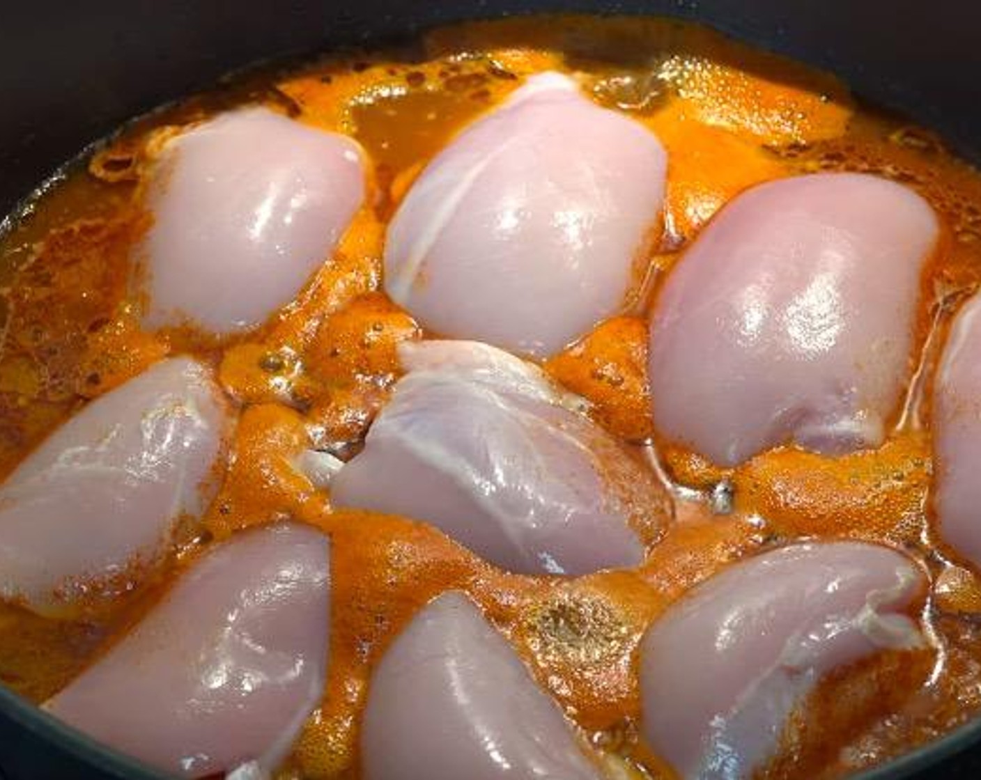 step 2 Arrange Boneless, Skinless Chicken Thighs (2.2 lb) across the bottom of the pan. Bring to a boil. Simmer for 45 minutes, or until chicken is cooked through.