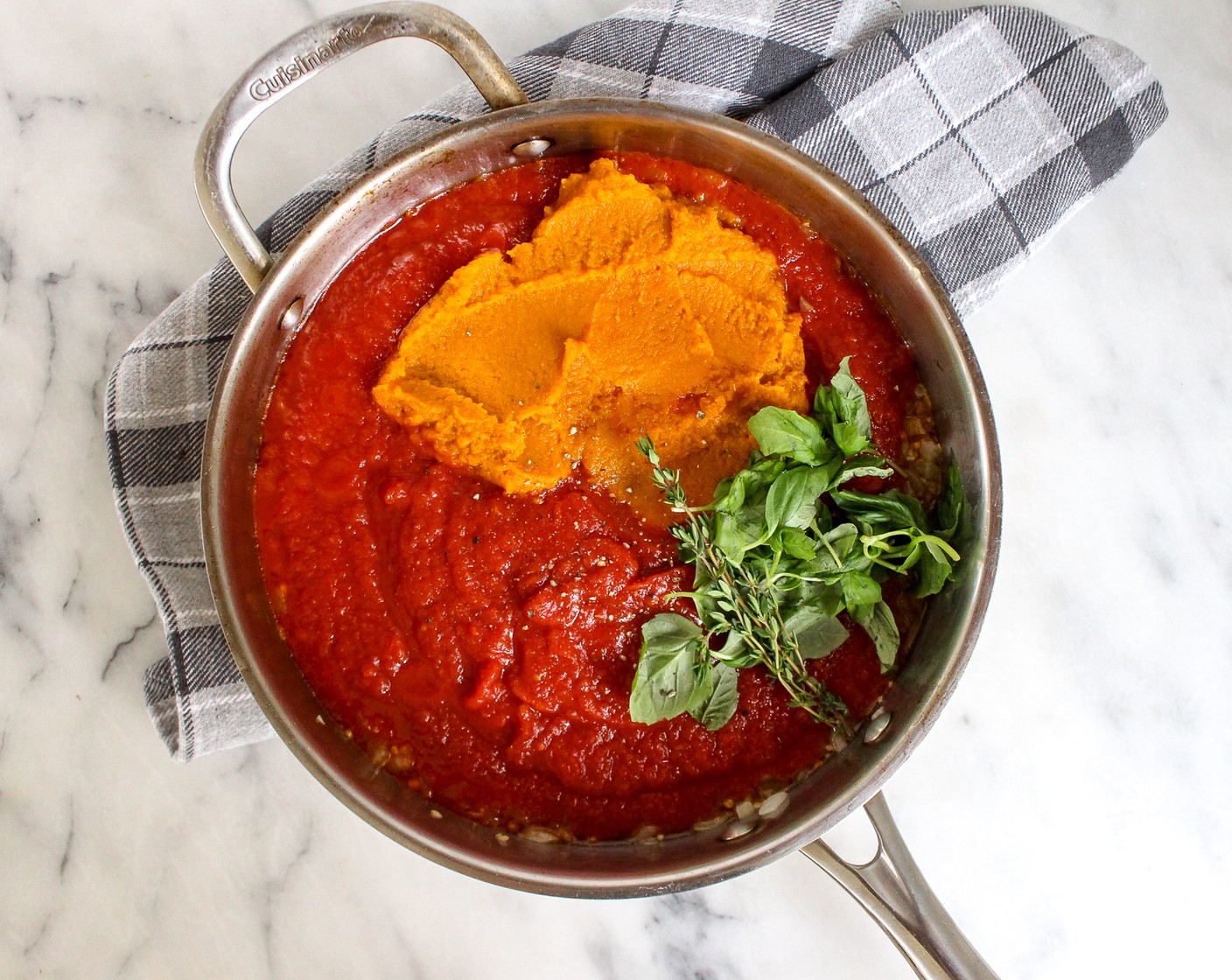 step 4 Add the Crushed Tomatoes (1 can), Pumpkin Purée (1 can), Fresh Basil Leaf (1/2 cup), Fresh Thyme (2 sprigs), Ground Cinnamon (1/2 tsp), Italian Seasoning (1 Tbsp), ¼ teaspoon salt, and Ground Black Pepper (1/4 tsp). Add ½-1 cup Vegetable Stock (1 cup) to thin out sauce, as needed. Mix together until simmering, then add the cooked lentils.