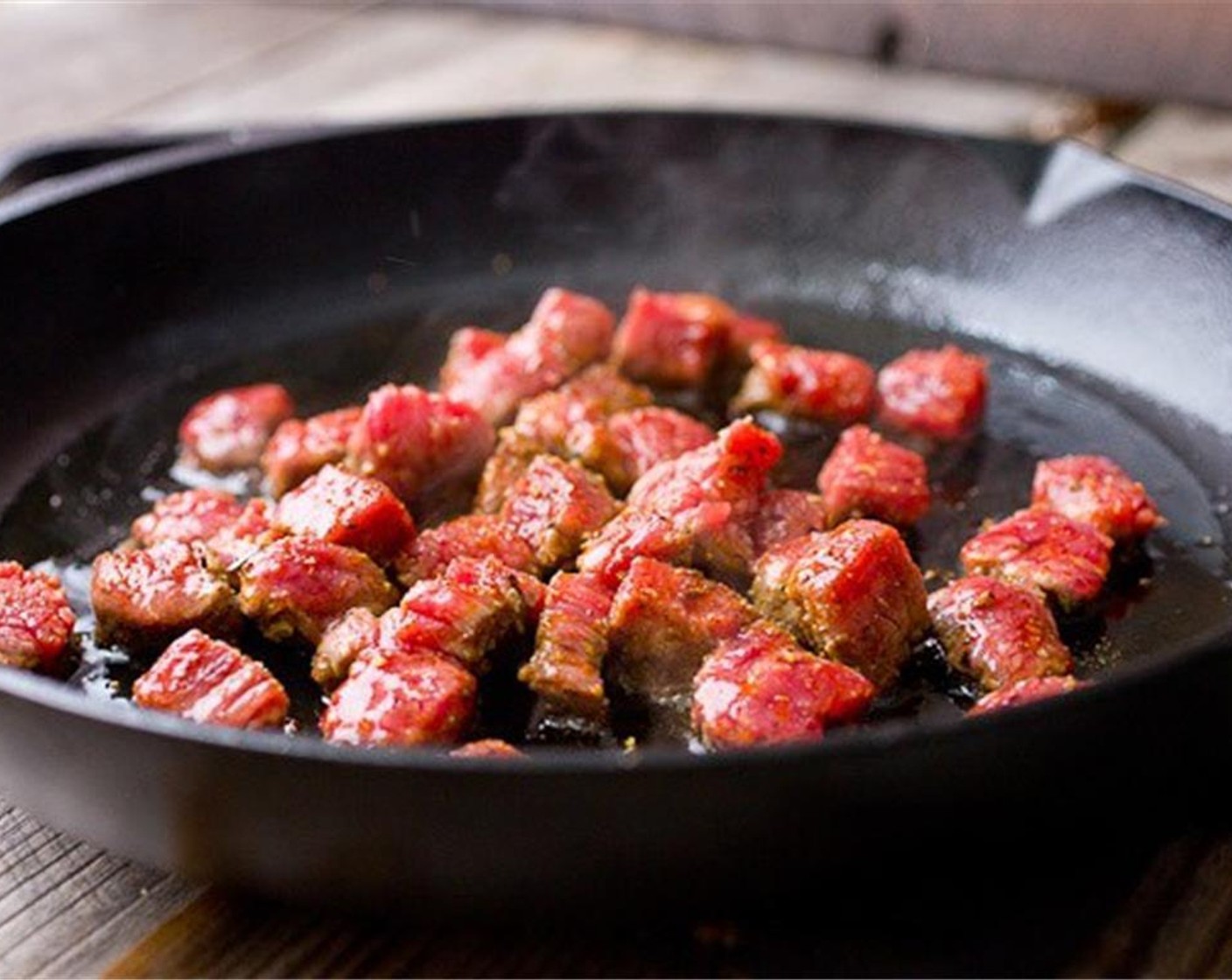 step 3 Add Olive Oil (1 Tbsp) and the seasoned steak to the skillet. Cook it over medium to medium-high heat for a few minutes until the steak is seared.