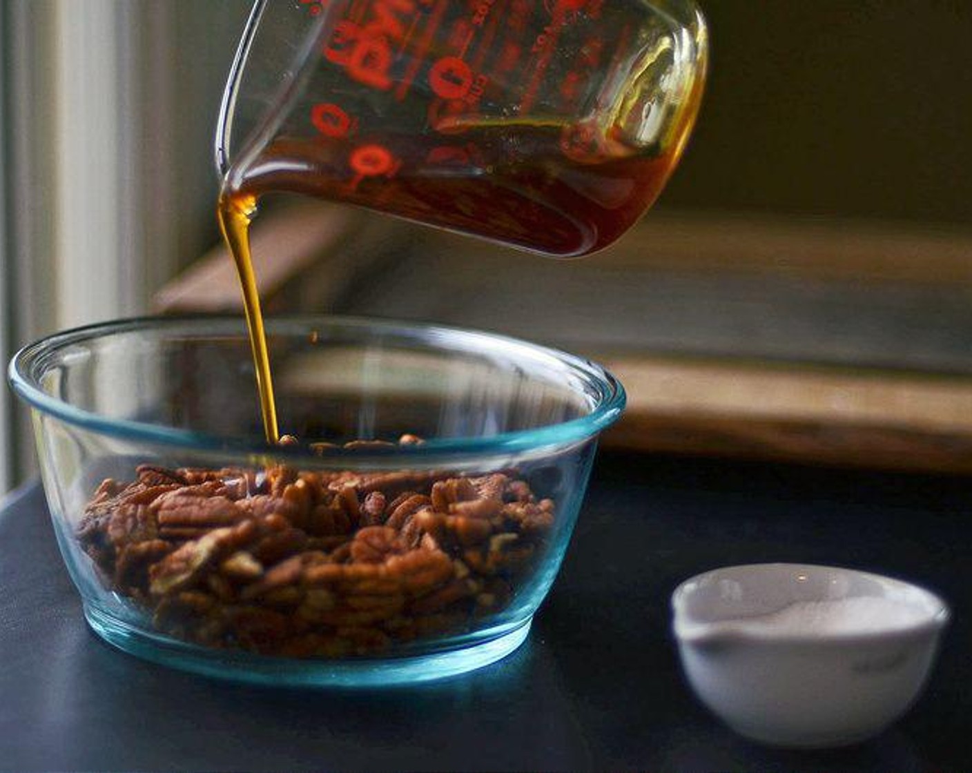 step 3 Place Pecan Halves (3 cups) in a medium mixing bowl and pour warmed honey over pecans. Toss to coat pecans well.