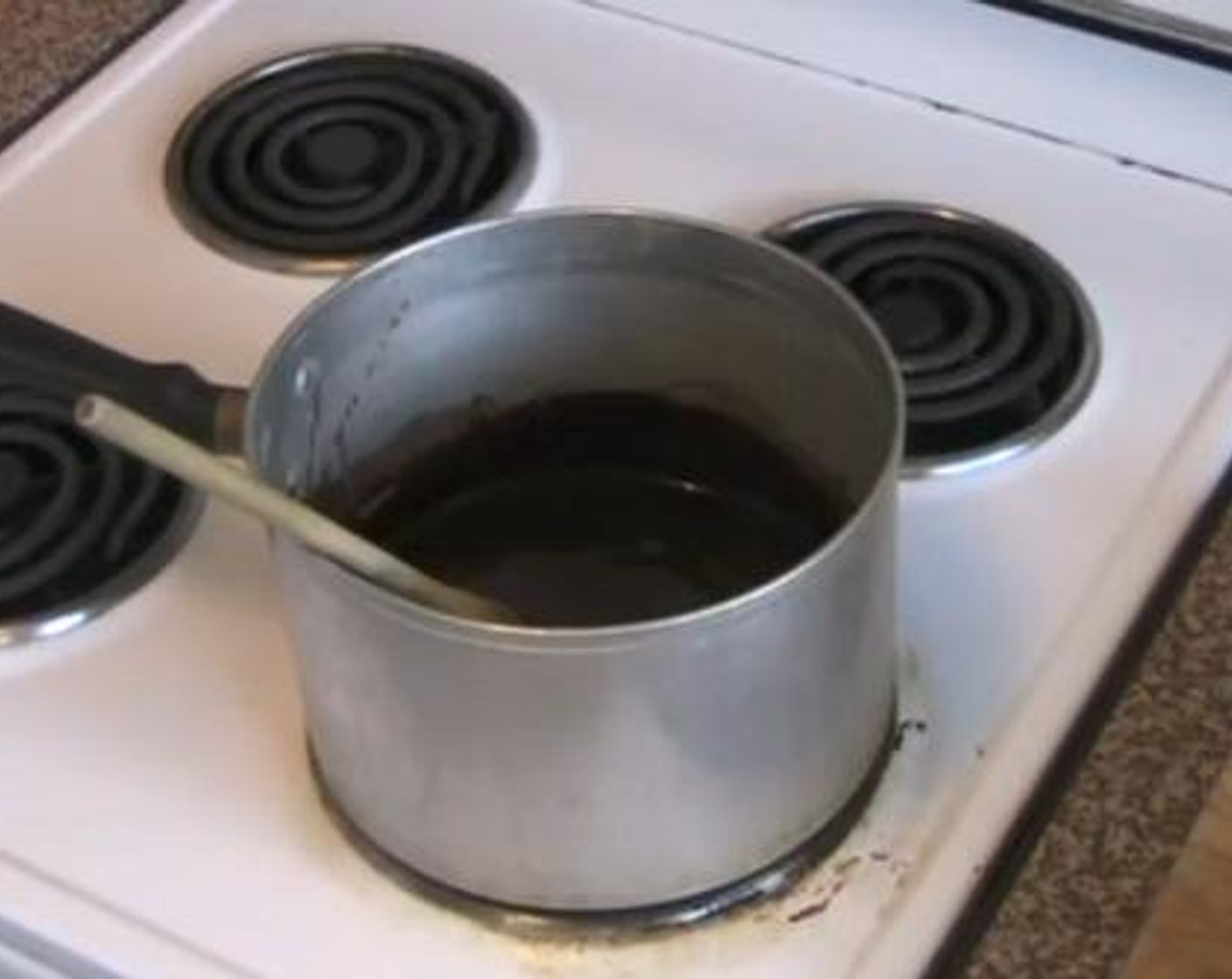 step 5 Meanwhile make the chocolate garnache. In a sauce pan, melt together the Unsalted Butter (1/2 cup), Dark Chocolate (1 cup). To that, add and mix Thickened Cream (1 Tbsp), and Powdered Confectioners Sugar (2 Tbsp). Take the mixture off the heat and let it cool for a few minutes.