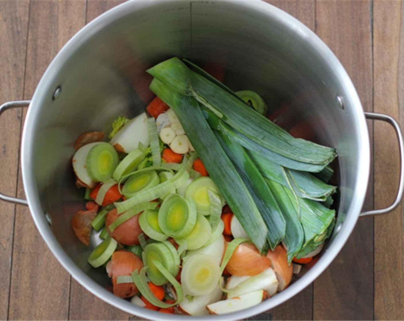 step 3 Cut off the dark green part of the leeks  and leave them whole. Slice up the light part of the leeks and place into the stockpot.