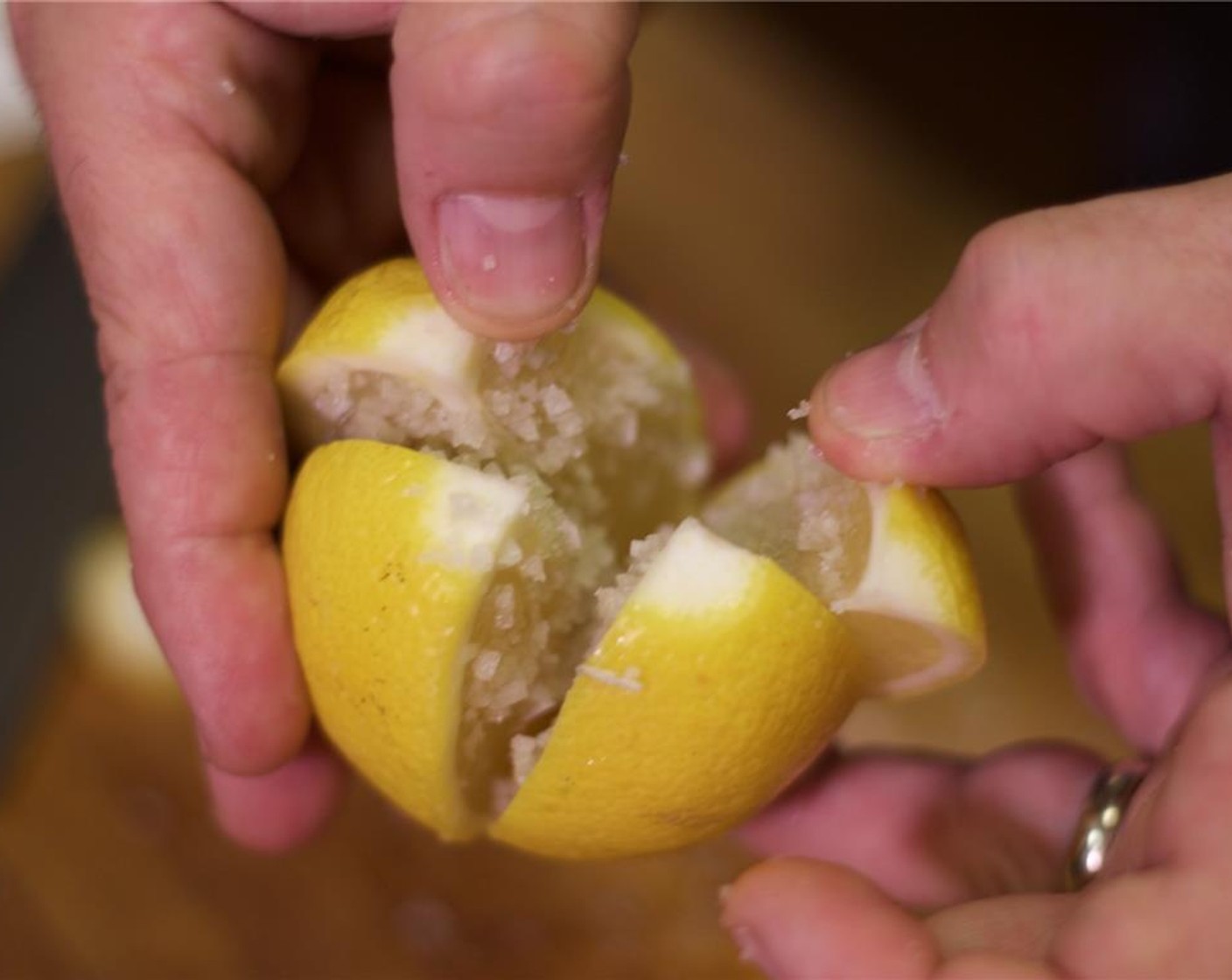 step 2 Slice the lemon into quarters, while making sure to keep it whole. Season the inside heavily with Kosher Salt (to taste).