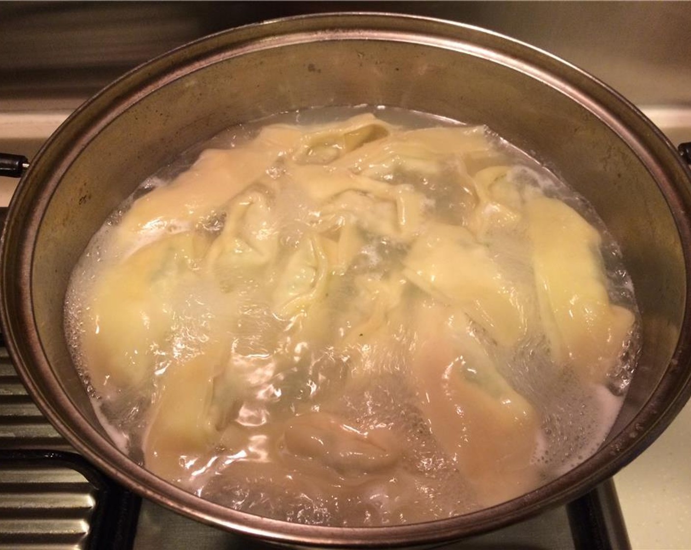 step 8 In a pot of boiling water, cook 10 dumplings for 7-10 minutes. The wanton skins will be slightly translucent and the dumplings will have floated to the top.