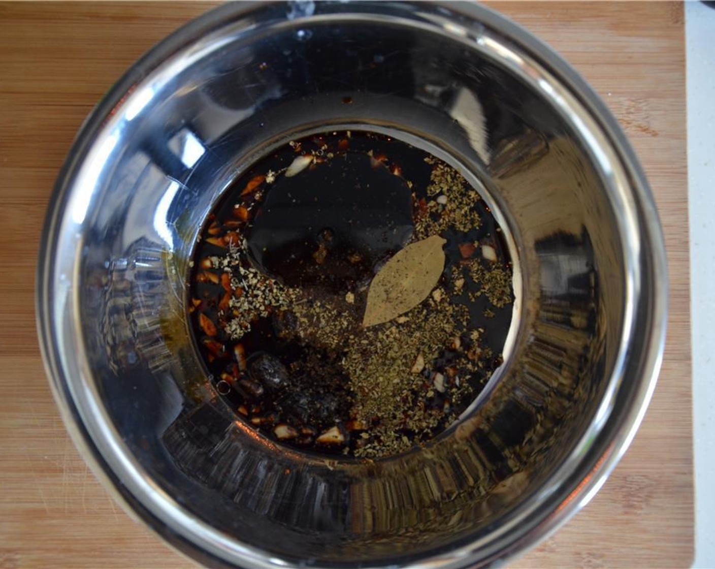 step 3 In a bowl, mix the Soy Sauce (3 Tbsp), Distilled White Vinegar (1 1/2 Tbsp), minced garlic, Simply Organic Garlic Powder (1/2 tsp), Brown Sugar (2 1/2 Tbsp), Oil (2 tsp), Ground Black Pepper (1/2 tsp), Bay Leaf (1) and Dried Oregano (1/2 tsp).