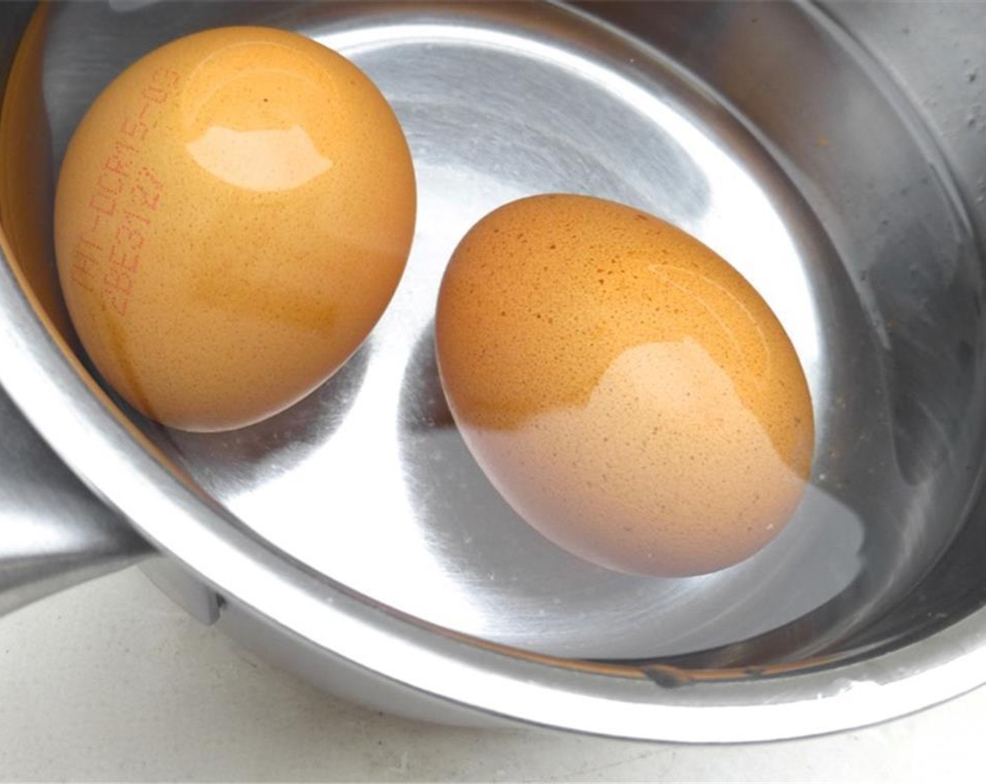 step 1 First of all, cook the whole Eggs (2). Fill a medium saucepan with water and place it over high heat. Once boiling, turn the heat to medium and carefully add the eggs using a tablespoon.