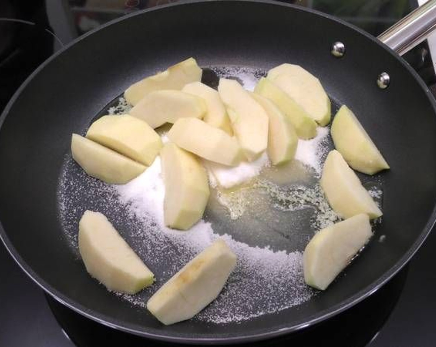 step 2 Place the Butter (1/4 cup) and Granulated Sugar (1/4 cup) in a pan and add the apple slices.