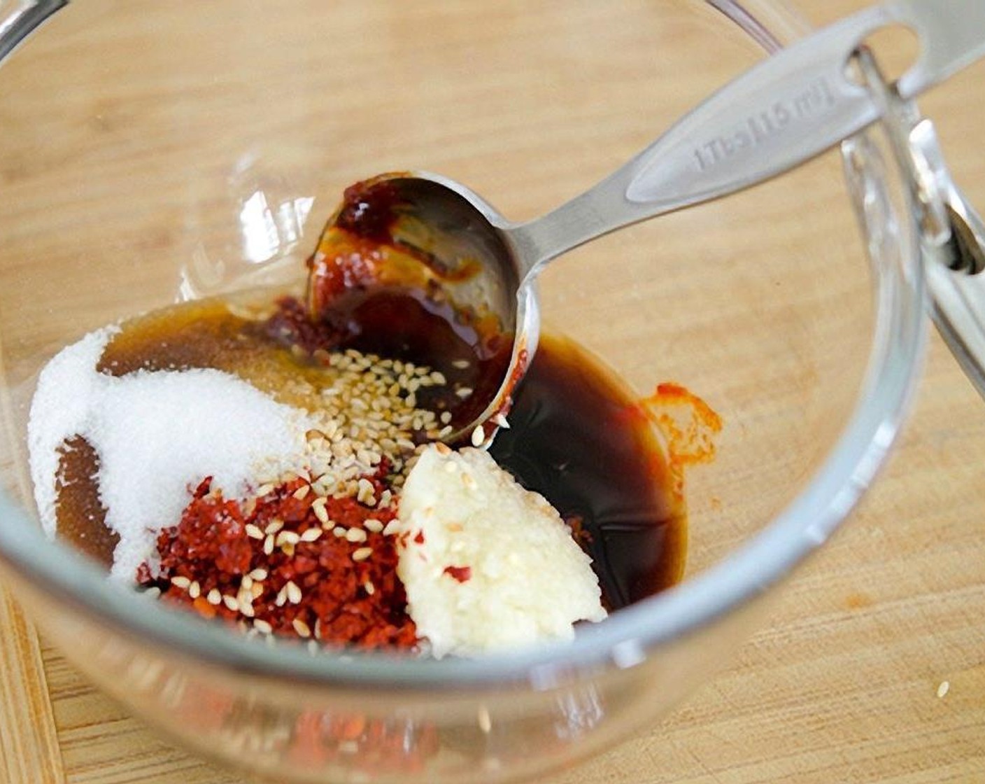 step 4 In a small mixing bowl combine Gochujang (3 Tbsp), Korean Chili Flakes (2 Tbsp), Soy Sauce (1 Tbsp), Granulated Sugar (1 Tbsp), Garlic, Ginger, Sesame Oil (1 Tbsp), and Corn Syrup (1 Tbsp).