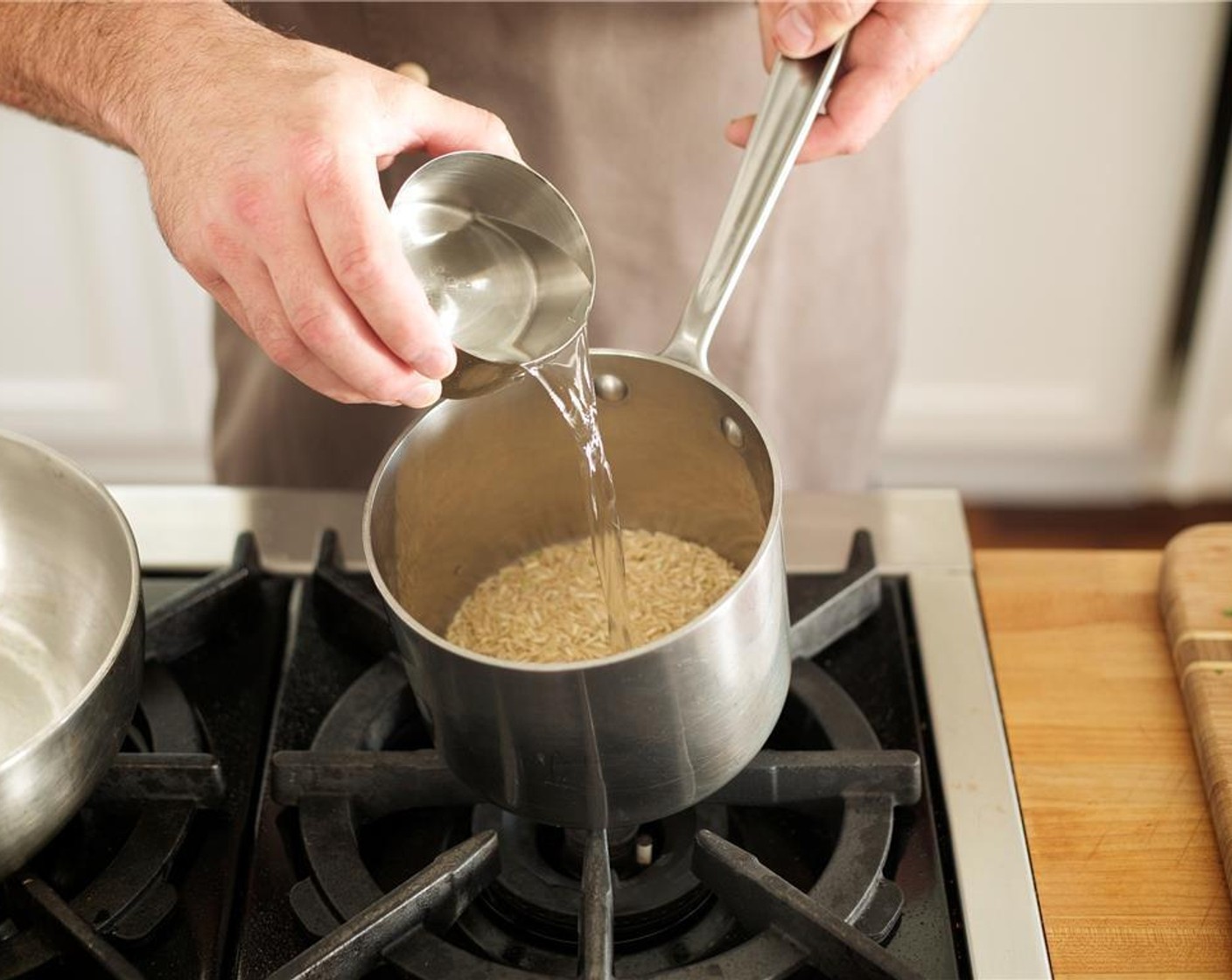 step 2 Add Brown Rice (2/3 cup) to small saucepan with one cup of cold water. Stir, bring to a boil over high heat, cover and lower heat to a simmer. Cook for 28 minutes or until rice is tender. Remove from heat, fluff rice, and keep covered until plating.