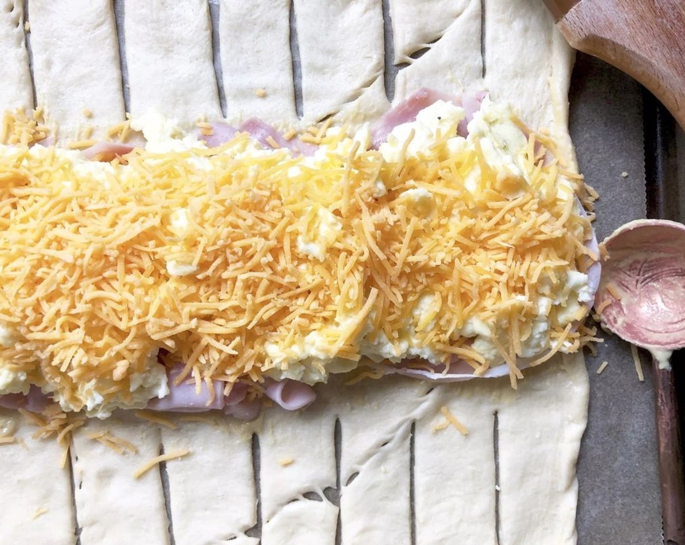 step 7 Next, add an even layer of Deli Ham (2 oz), then the scrambled eggs and Shredded Cheddar Cheese (1/2 cup).